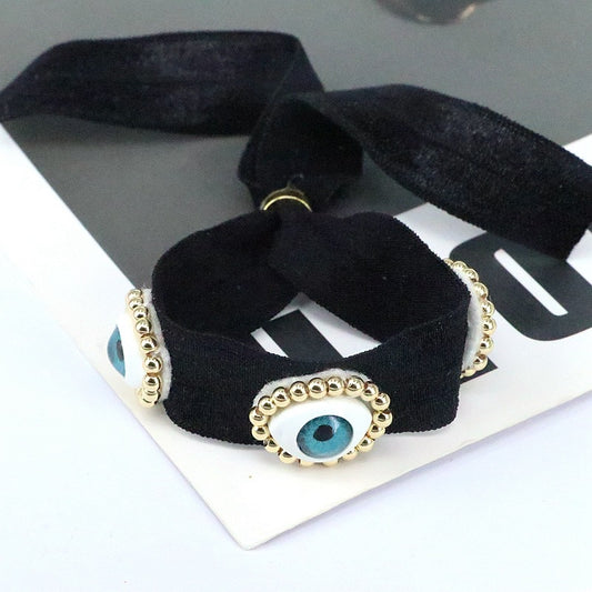 Pulsera negra con ojos
